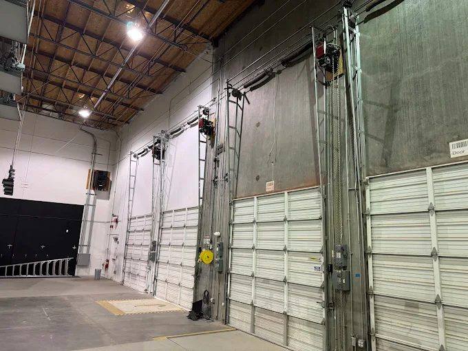Industrial sectional doors with jackshaft operators in a Riverside County warehouse