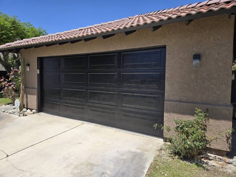Black steel garage door on a tile-roof home in the Coachella Valley