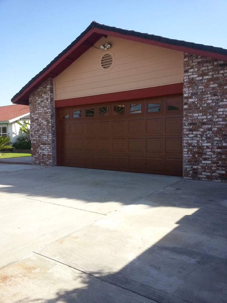 Brown steel garage door on a brick-fronted home near the San Gorgonio Pass