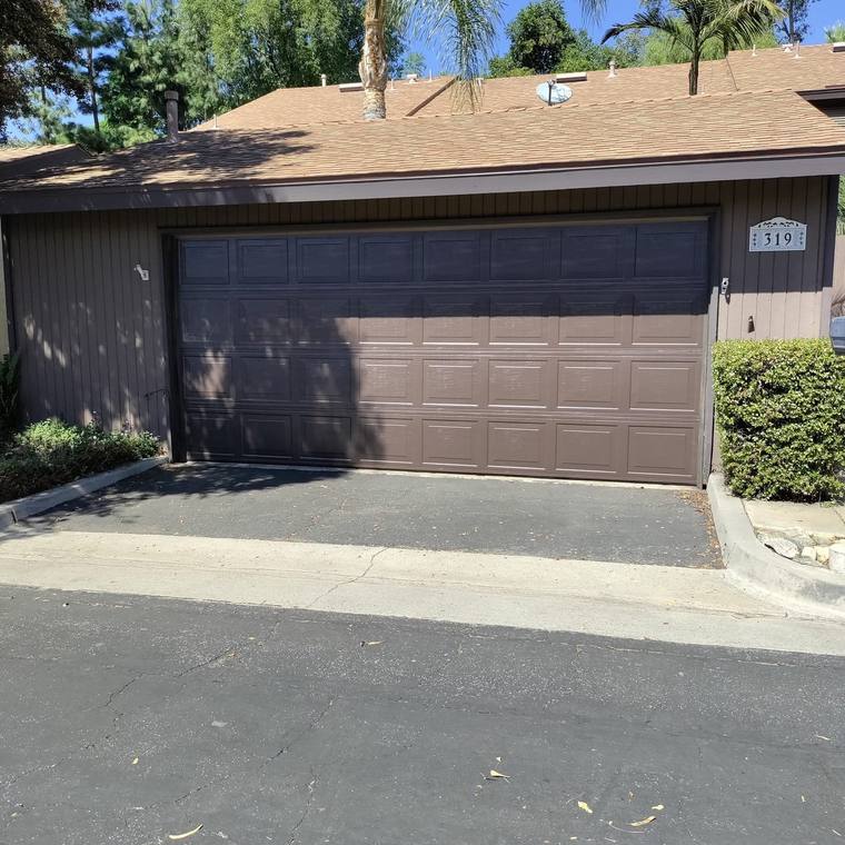 Brown raised-panel steel garage door on a Riverside County home