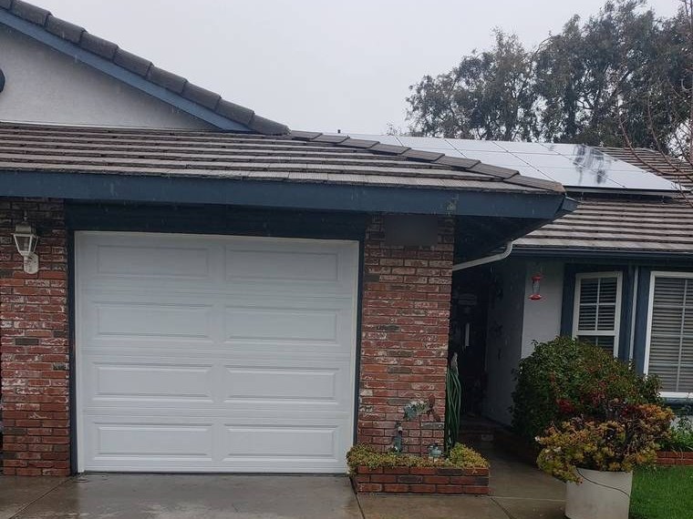 White single-car steel garage door on a brick-fronted ranch home — installed and serviced by Riverside Classic Garage Doors across Riverside County, California