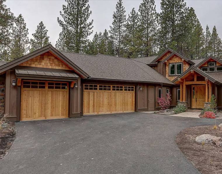 Natural cedar craftsman garage doors with divided-light windows