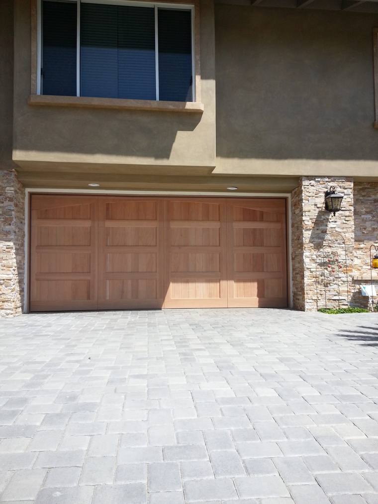 Cedar carriage garage door detail with paver driveway
